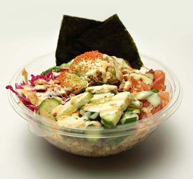 A salmon poke bowl with miso sushi rice, seaweed salad, avocado, tobiko, cucumber, pickled cabbage, sriracha mayo sauce